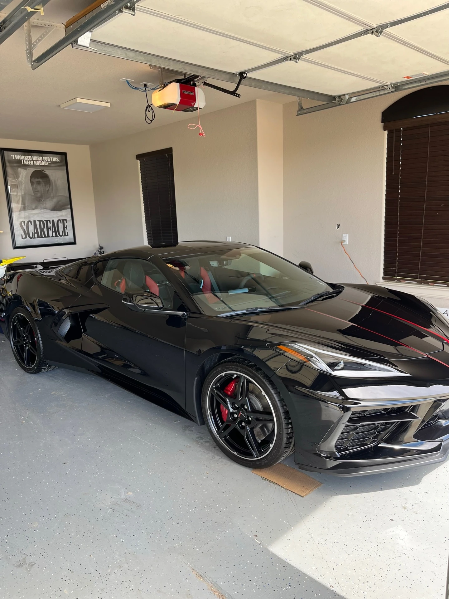 Black Corvette C8 with corrected, mirror-flat paint after machine polishing