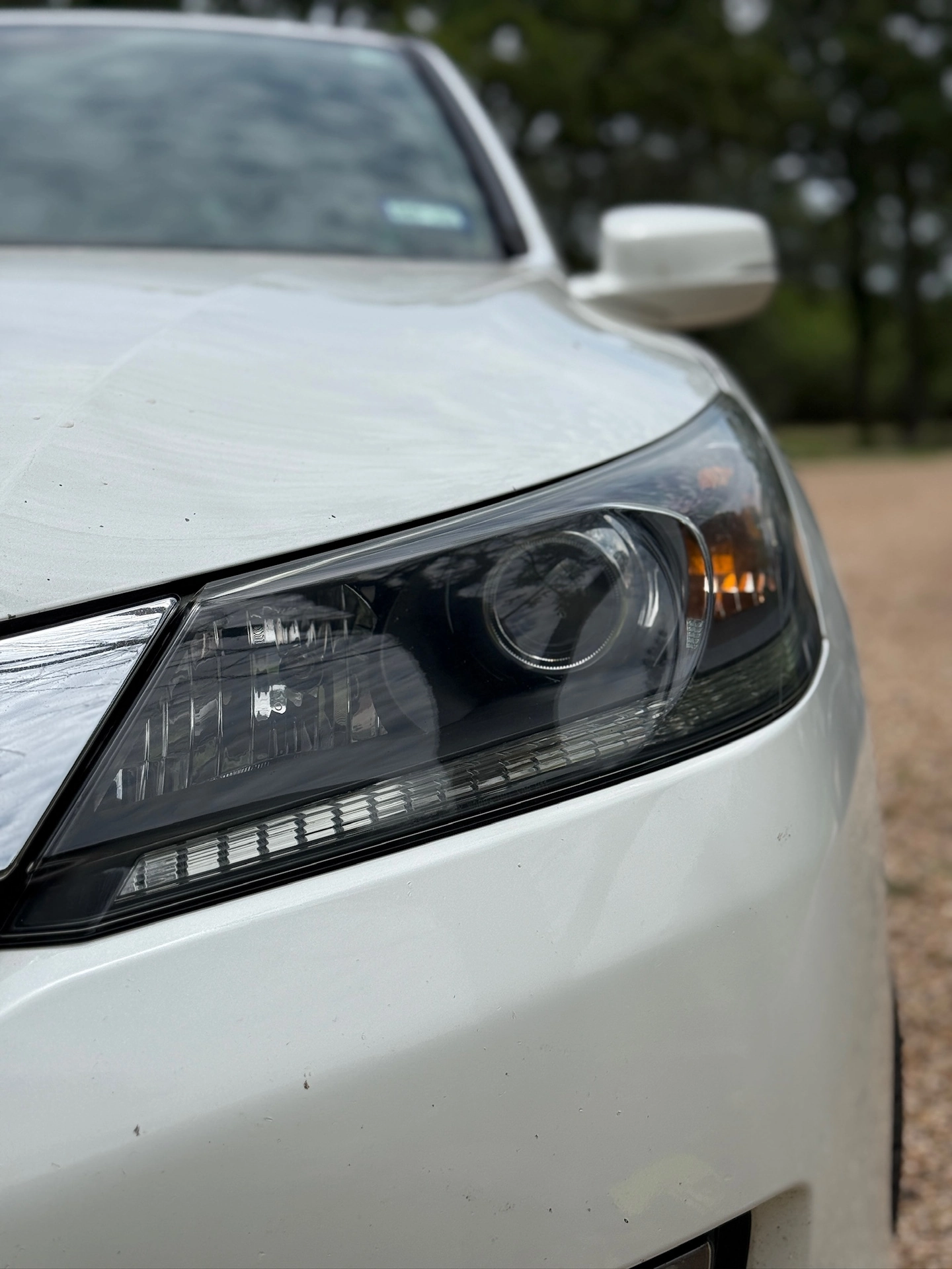 Clear headlight on a silver sedan after restoration